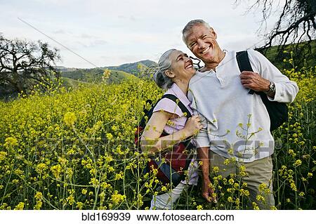 Caucasian couple standing in tall grass View Large Photo Image Stock Photo - Caucasian couple standing in tall grass. Fotosearch