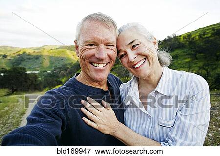 Stock Photo - Caucasian couple standing on hiking trail. Fotosearch