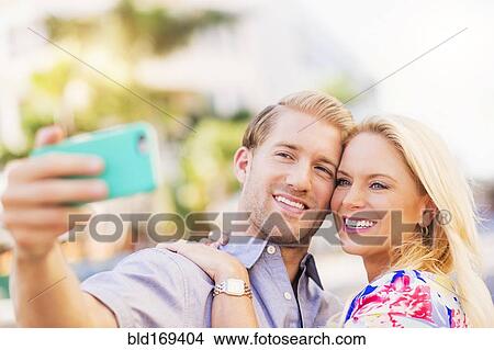 Caucasian couple taking selfie on cell phone View Large Photo Image Picture - Caucasian couple taking selfie on cell phone. Fotosearch