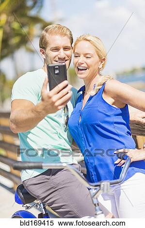 Caucasian couple taking selfie with cell phone View Large Photo Image Stock Photography - Caucasian couple taking selfie with cell phone. Fotosearch