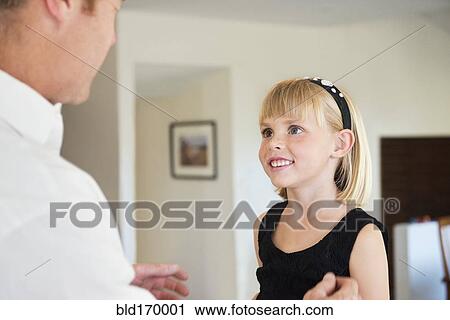 Caucasian father and daughter talking in living room View Large Photo Image Stock Image - Caucasian father and daughter talking in living room. Fotosearch