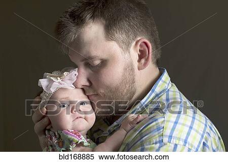 Stock Photography - Caucasian father holding daughter. Fotosearch