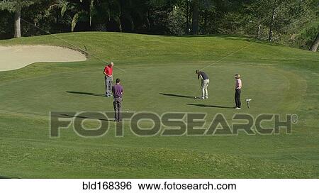 Caucasian friends putting on golf course View Large Photo Image Stock Photograph - Caucasian friends putting on golf course. Fotosearch