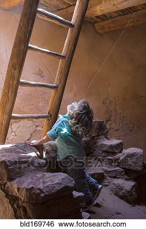 Stock Photograph - Caucasian girl exploring Native American ruins at Pecos National Monument, Pecos, New Mexico, United States. Fotosearch