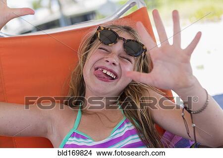 Picture - Caucasian girl making a face on beach. Fotosearch