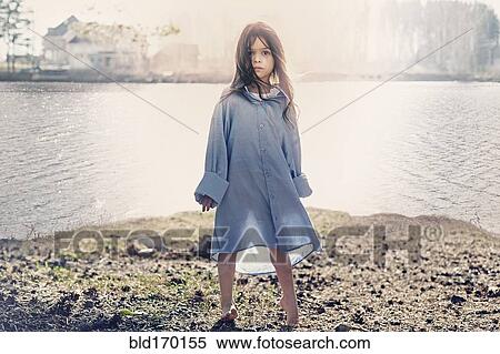 Caucasian girl standing at rural lake View Large Photo Image Stock Photography - Caucasian girl standing at rural lake. Fotosearch