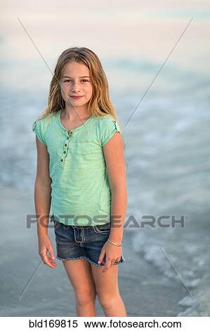 Caucasian girl standing in ocean waves View Large Photo Image Stock Photography - Caucasian girl standing in ocean waves. Fotosearch