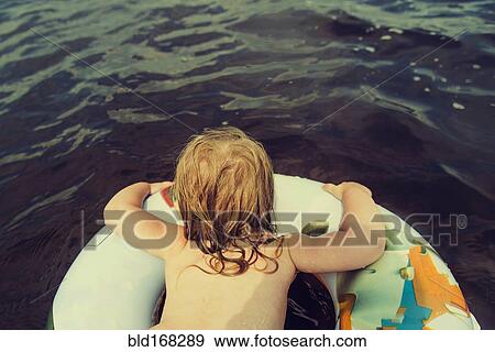 Stock Photo - Caucasian girl swimming in lake. Fotosearch