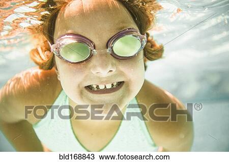 Caucasian girl swimming underwater in swimming pool View Large Photo Image Stock Image - Caucasian girl swimming underwater in swimming pool. Fotosearch