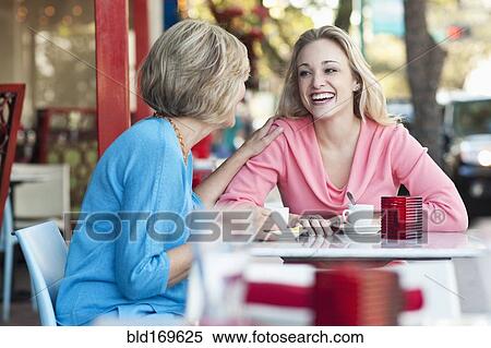 Caucasian mother and daughter drinking coffee at sidewalk cafe View Large Photo Image Stock Photography - Caucasian mother and daughter drinking coffee at sidewalk cafe. Fotosearch