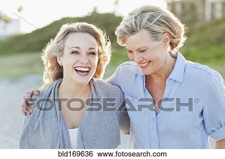 Caucasian mother and daughter hugging on beach View Large Photo Image Stock Photograph - Caucasian mother and daughter hugging on beach. Fotosearch