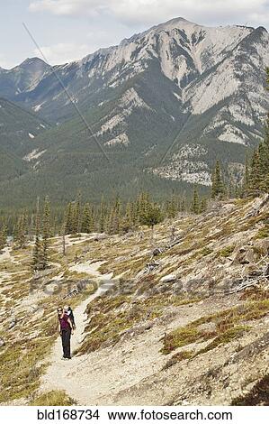 Picture - Caucasian mother and son hiking on remote hillside. Fotosearch