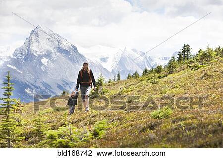 Caucasian mother and son hiking on remote hillside View Large Photo Image Stock Image - Caucasian mother and son hiking on remote hillside. Fotosearch