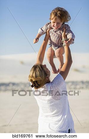 Caucasian mother and son playing in desert View Large Photo Image Stock Image - Caucasian mother and son playing in desert. Fotosearch