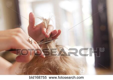 Stock Photography - Caucasian mother cutting hair of son. Fotosearch