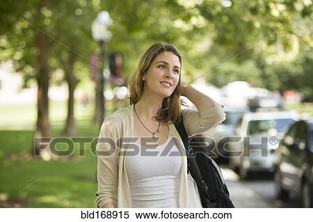 Caucasian student carrying backpack on sidewalk View Large Photo Image Stock Photography - Caucasian student carrying backpack on sidewalk. Fotosearch