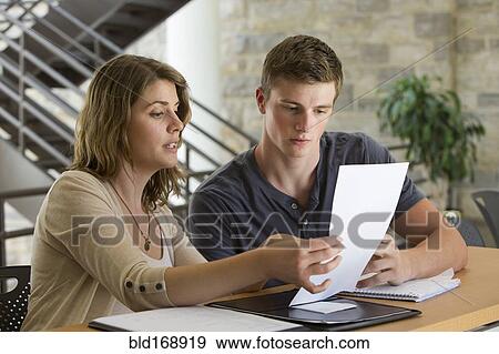 Stock Photo - Caucasian students studying at table. Fotosearch