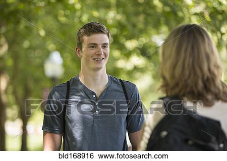 Caucasian students talking on sidewalk View Large Photo Image Stock Photograph - Caucasian students talking on sidewalk. Fotosearch