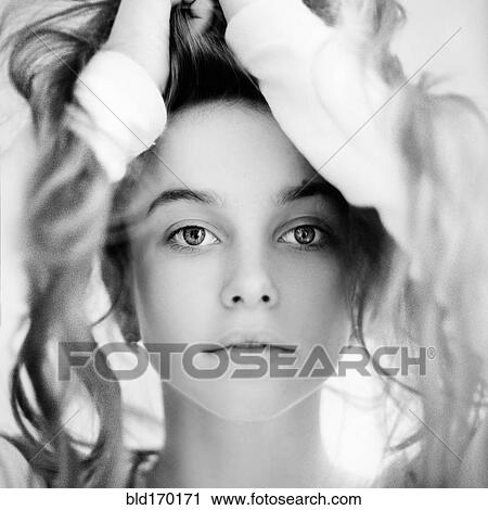 Caucasian teenage girl playing with messy hair View Large Photo Image Stock Image - Caucasian teenage girl playing with messy hair. Fotosearch