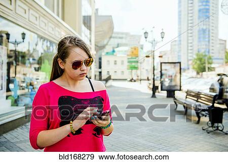 Stock Photo - Caucasian teenage girl using cell phone. Fotosearch