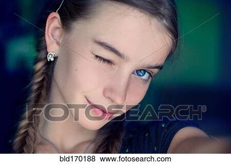 Stock Photo - Caucasian teenage girl winking. Fotosearch