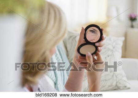 Caucasian woman admiring herself in mirror View Large Photo Image Stock Photo - Caucasian woman admiring herself in mirror. Fotosearch