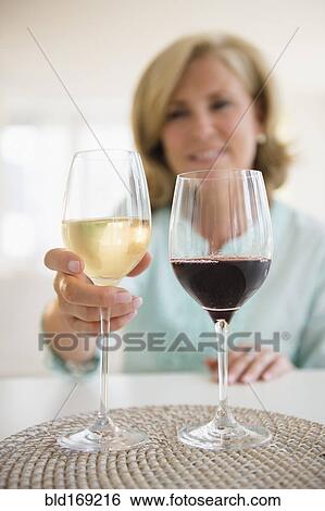 Caucasian woman choosing white wine and red wine View Large Photo Image Stock Photograph - Caucasian woman choosing white wine and red wine. Fotosearch