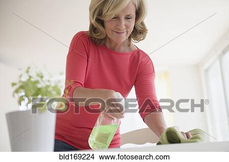Caucasian woman cleaning table View Large Photo Image Picture - Caucasian woman cleaning table. Fotosearch