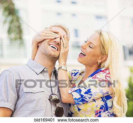 Caucasian woman covering eyes of husband View Large Photo Image Stock Image - Caucasian woman covering eyes of husband. Fotosearch