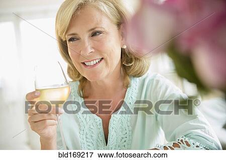 Stock Photo - Caucasian woman drinking white wine. Fotosearch