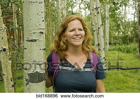 Stock Photograph - Caucasian woman hiking in forest. Fotosearch