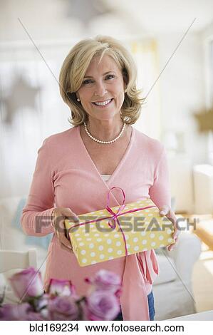 Picture - Caucasian woman holding gift. Fotosearch