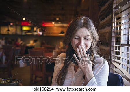 Picture - Caucasian woman laughing in bar. Fotosearch