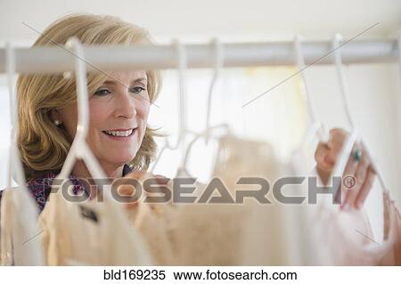 Caucasian woman shopping in clothing store View Large Photo Image Stock Photography - Caucasian woman shopping in clothing store. Fotosearch
