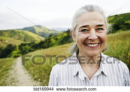 Picture - Caucasian woman standing on hiking trail. Fotosearch
