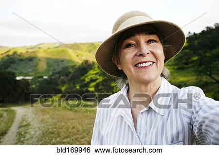 Stock Photograph - Caucasian woman standing on hiking trail. Fotosearch