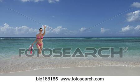 Caucasian woman wading on beach with flippers and snorkel View Large Photo Image Stock Photography - Caucasian woman wading on beach with flippers and snorkel. Fotosearch