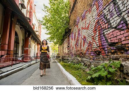 Caucasian woman walking in city street View Large Photo Image Stock Photograph - Caucasian woman walking in city street. Fotosearch