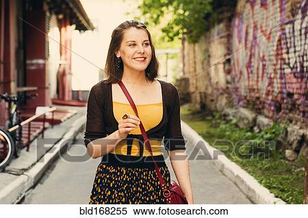 Caucasian woman walking in city street View Large Photo Image Stock Photography - Caucasian woman walking in city street. Fotosearch