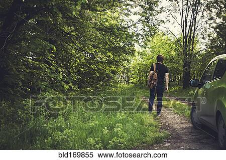 Caucasian woman walking on dirt path View Large Photo Image Stock Photography - Caucasian woman walking on dirt path. Fotosearch
