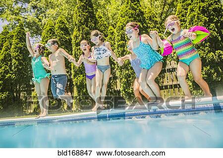 Children jumping into swimming pool View Large Photo Image Stock Photo - Children jumping into swimming pool. Fotosearch