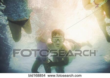 Children swimming underwater in swimming pool View Large Photo Image Picture - Children swimming underwater in swimming pool. Fotosearch