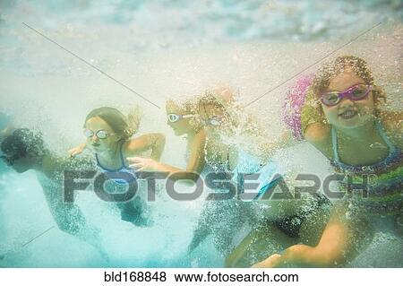 Stock Photo - Children underwater in swimming pool. Fotosearch