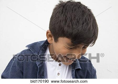 Stock Image - Close up of Asian boy laughing. Fotosearch