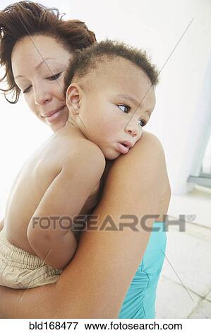 Stock Photo - Close up of Black mother comforting son. Fotosearch