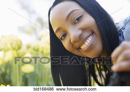 Stock Photograph - Close up of Black woman smiling. Fotosearch