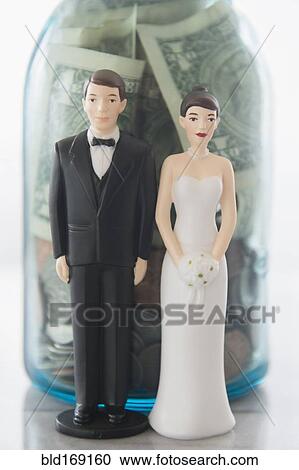 Close up of bride and groom dolls near savings jar View Large Photo Image Stock Image - Close up of bride and groom dolls near savings jar. Fotosearch
