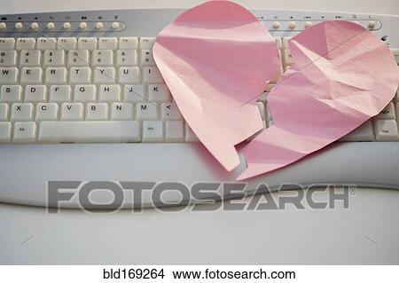 Picture - Close up of broken heart on computer keyboard. Fotosearch