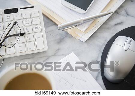 Close up of computer equipment, files and coffee on office desk View Large Photo Image Stock Photo - Close up of computer equipment, files and coffee on office desk. Fotosearch