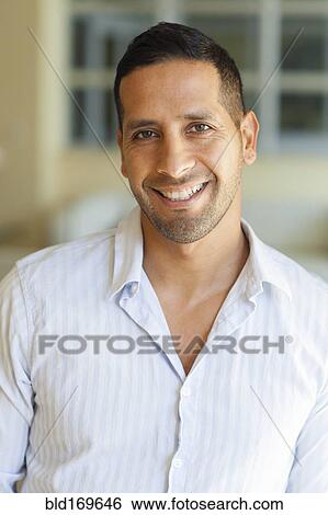 Stock Photograph - Close up of Hispanic man smiling. Fotosearch
